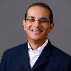 Headshot portrait of Anil C. Currimjee