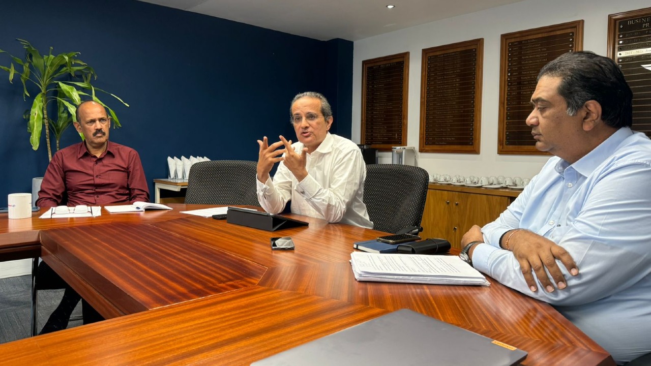 Anil C. Currimjee in a working discussion around a boardroom table
